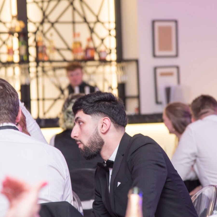 Adam Khan in a tuxedo at a formal event